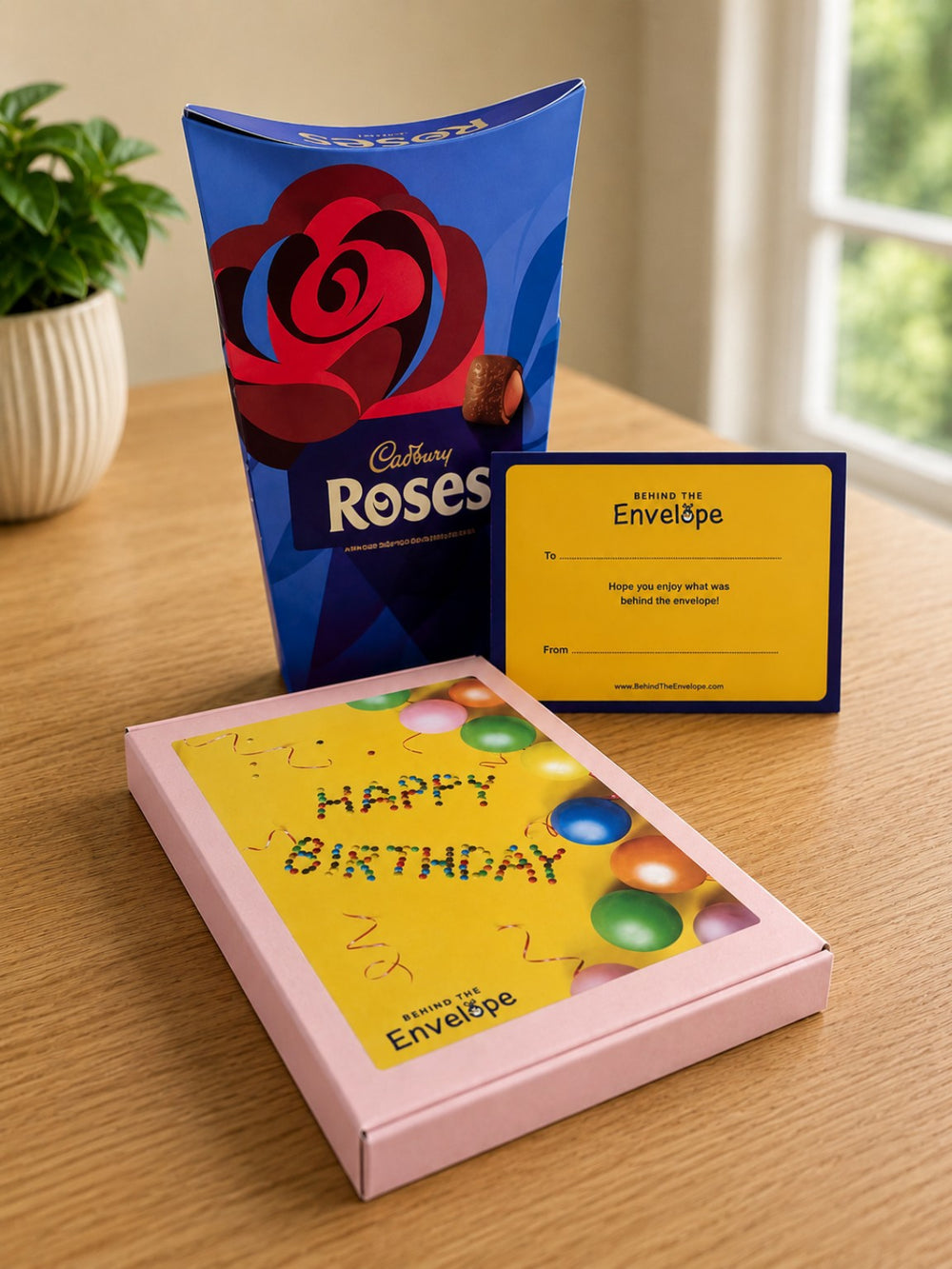 Pink Behind The Envelope birthday gift box with Cadbury Roses and personalised gift card